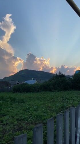 Sunset light over fields and fences in rural Maloarslangulovo