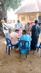 Live music and a casual outdoor gathering in a village setting