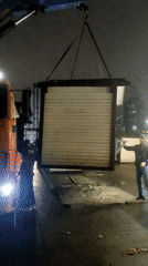 Nighttime crane operation lifts wooden structure in Saint Petersburg