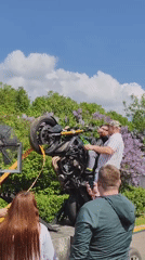 Kawasaki motorcycle performs wheelie stunt on platform in Moscow