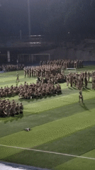 Military personnel gather on turf field in Shapingba District
