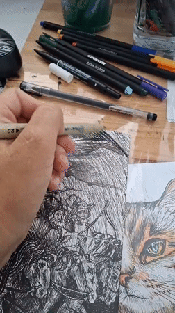 Ink illustration session in progress, with a kitten in attendance