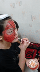 Spider-Man face paint session captured in Bishkek