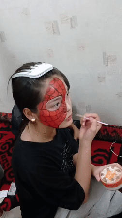 Spider-Man face paint session captured in Bishkek