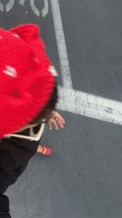 Person films self wearing strawberry hat in Los Angeles