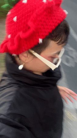 Person films self wearing strawberry hat in Los Angeles