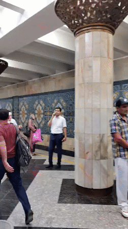 Inside Tashkent's Kosmonavtlar metro station, ornate and in motion