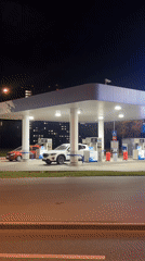 Nighttime gas station corner with bus and crosswalk, Moscow