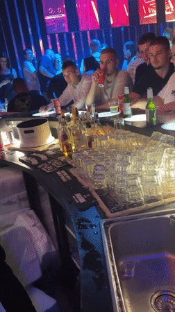 Nightclub patrons socialize at bar in Gotse Delchev, Bulgaria