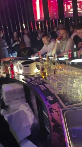 Nightclub patrons socialize at bar in Gotse Delchev, Bulgaria
