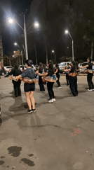 Dance group performs synchronized routine in Arica parking lot