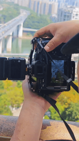 Photographer adjusts professional camera equipment in Yuzhong District