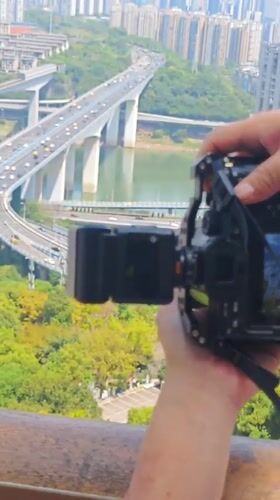 Photographer adjusts professional camera equipment in Yuzhong District