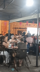 Candlelit tables and string lights at a Spanish village night gathering