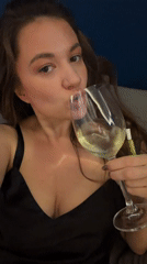 Woman enjoys white wine in relaxed Athens setting