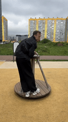 Adult uses children's playground equipment for workout in Murino
