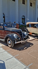 Classic car show outside Baden-Baden's neoclassical landmark, sunny July afternoon