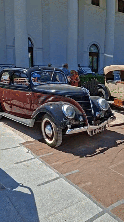 Classic car show outside Baden-Baden's neoclassical landmark, sunny July afternoon