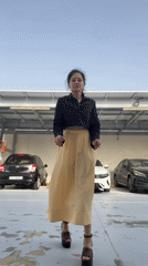 Woman smokes cigarette in parking garage