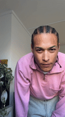 Man in pink sweatshirt dances to music in London