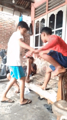 Boys play and socialize in residential Lhokseumawe neighborhood