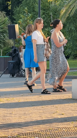 Street violinist performs in Sochi park during sunset hours