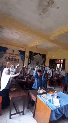 Students participate in religious recitation in Indonesian classroom