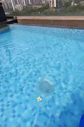 Early morning swimming lesson documented at Mumbai rooftop pool