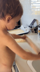 Toddler bakes in home kitchen in Kiryat Bialik