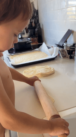 Toddler bakes in home kitchen in Kiryat Bialik