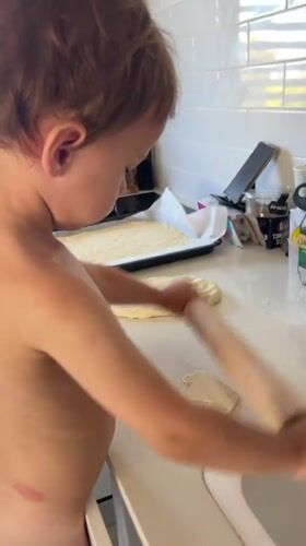 Toddler bakes in home kitchen in Kiryat Bialik
