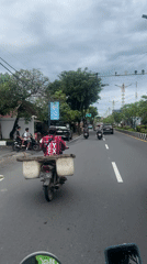 Scooter rider filmed on Kuta Selatan street during morning