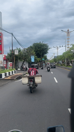 Scooter rider filmed on Kuta Selatan street during morning