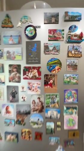Decorated refrigerator with family photos, magnets captured in Rusanovo