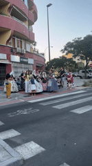 Traditional dress and street gathering outside Alicante's Wonder building