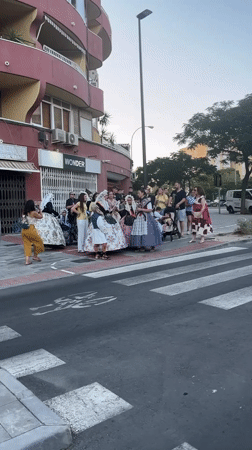 Traditional dress and street gathering outside Alicante's Wonder building