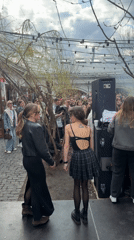 Outdoor gathering with stage performance captured in Moscow courtyard