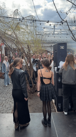 Outdoor gathering with stage performance captured in Moscow courtyard