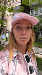 Woman in pink records direct-to-camera message in Almaty