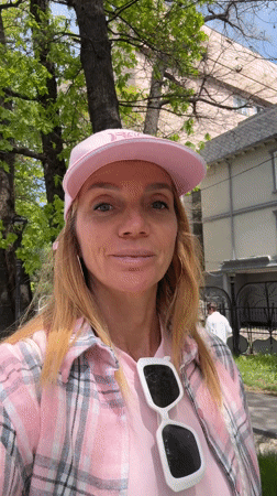 Woman in pink records direct-to-camera message in Almaty