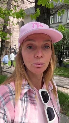 Woman in pink records direct-to-camera message in Almaty