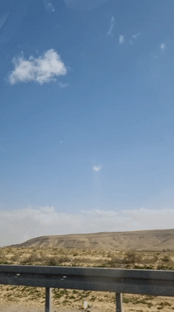 Vehicle passenger records desert landscape near Dimona, Israel