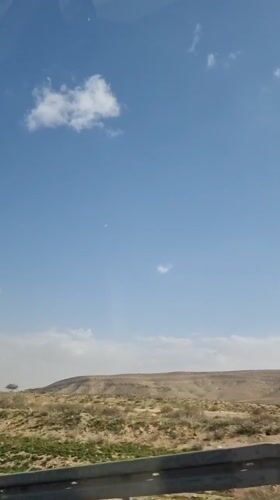 Vehicle passenger records desert landscape near Dimona, Israel