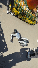Robot draws crowd at outdoor market as onlookers photograph