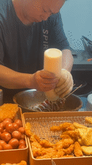 Street vendor serves fried foods at stall in Jiangjin