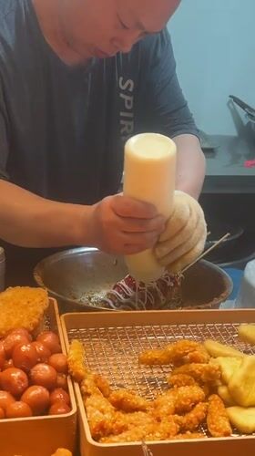 Street vendor serves fried foods at stall in Jiangjin