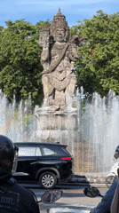 Morning traffic flows past Catur Muka fountain in Denpasar