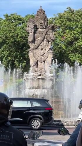 Morning traffic flows past Catur Muka fountain in Denpasar