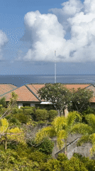 Tropical coastal town with tile roofs captured in morning views