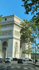 Morning traffic flows past Arc de Triomphe in Paris